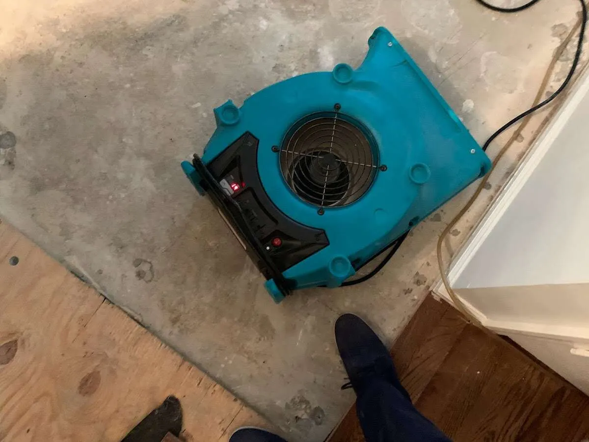 Air mover drying subfloor during Commercial Water Damage Restoration in East St. Louis